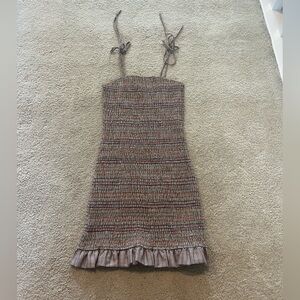 Multi-colored plaid patterned dress with a ruffled hem and tie up straps!